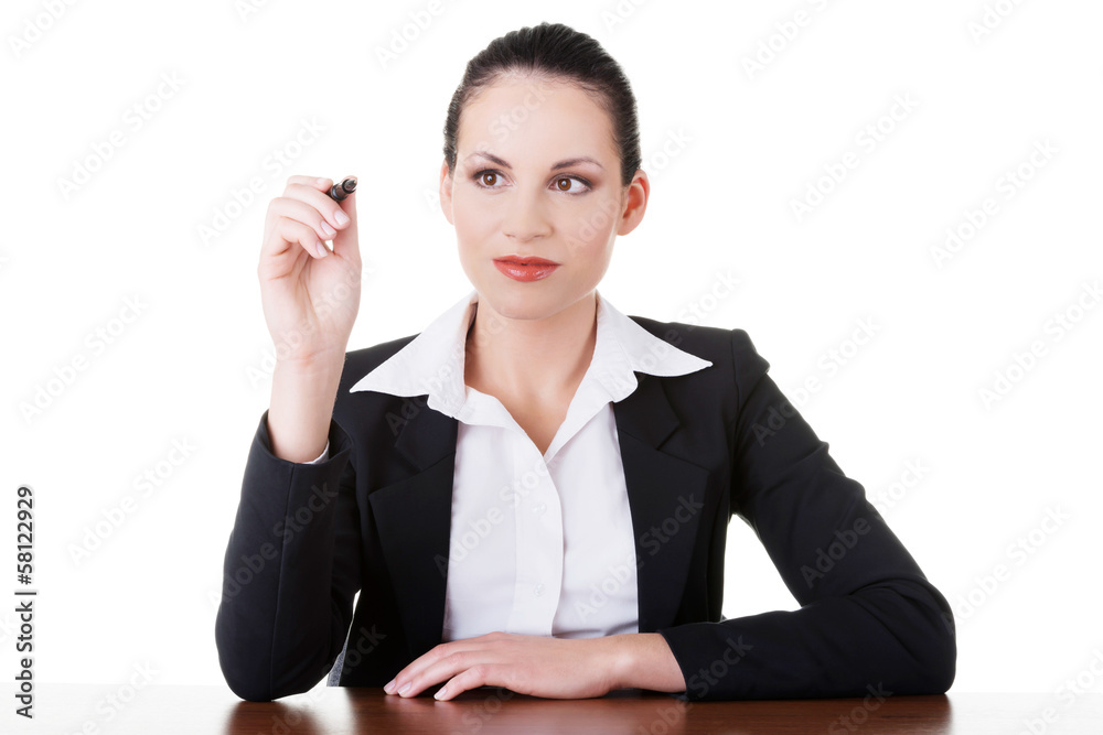 Business woman trying to write on copy space, sitting by table. Business woman trying to write on copy space, sitting by table.