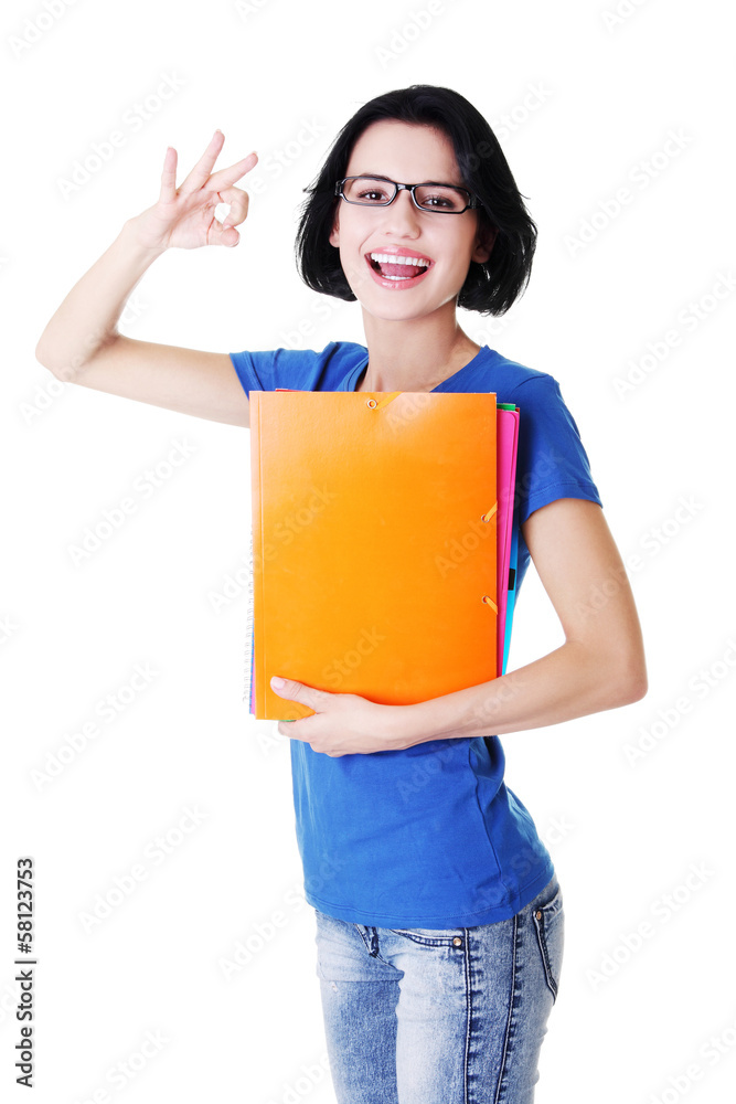 Attractive woman/student holding files and showing OK. Attractive woman/student holding files and showing OK.