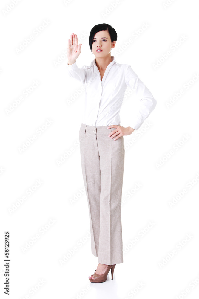 Attractive young woman showin stop by hand. Attractive young woman showin stop by hand.