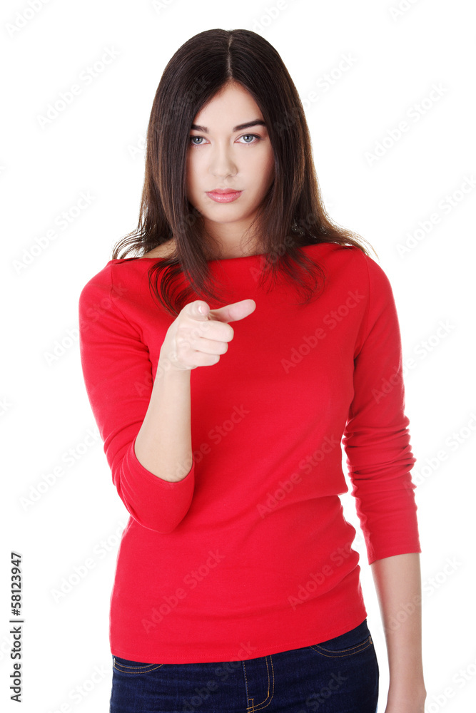 Attractive woman pointing in front.