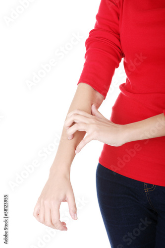 Attractive woman scratching herself. Hand closeup.