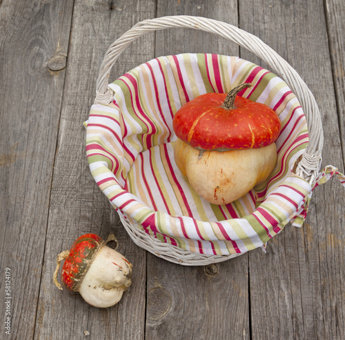 Decorative pumpkins is in a basket photo