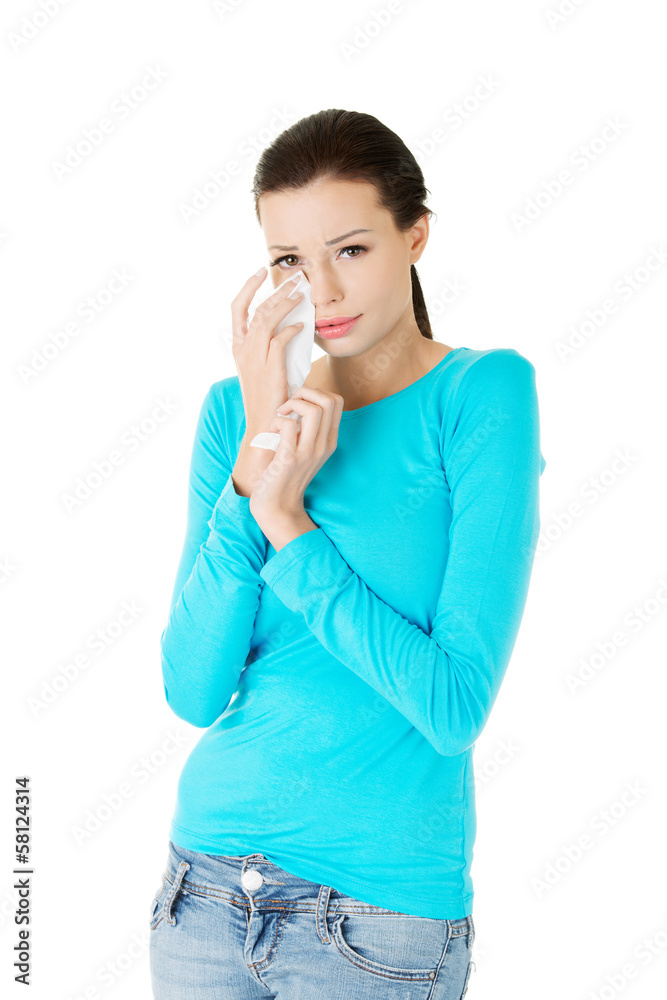 Attractive woman crying, holding a tissue. Attractive woman crying, holding a tissue.