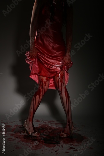Fototapeta Naklejka Na Ścianę i Meble -  Scary Woman Dripping in Blood Wearing Prom Dress