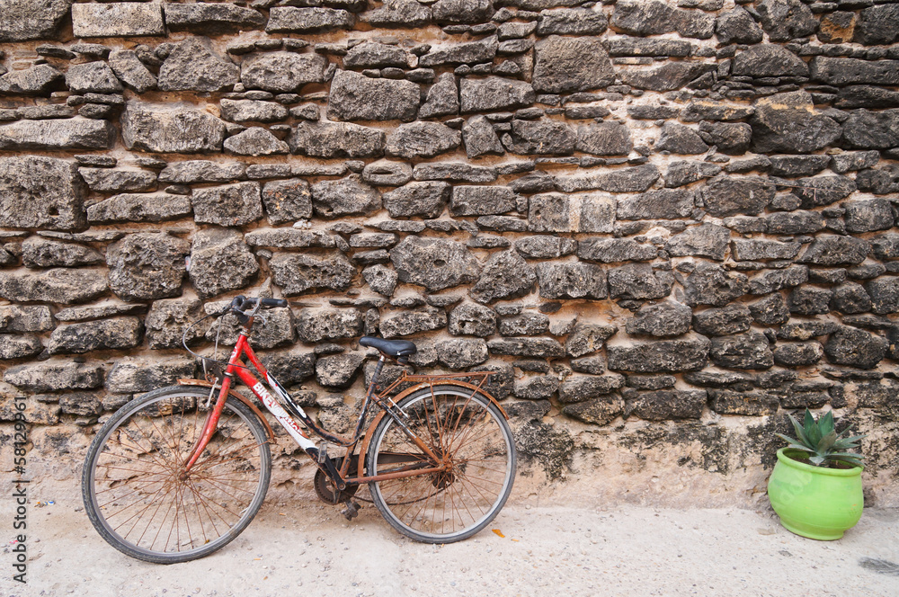 Red bicycle and green pot at Mazagan Fortress wall, El-Jadida Red bicycle and green pot at Mazagan Fortress wall, El-Jadida