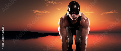 Fotografie Swimmer muscled triathlon man with cap and glasses outdoor at a