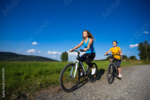 Healthy lifestyle - young women biking