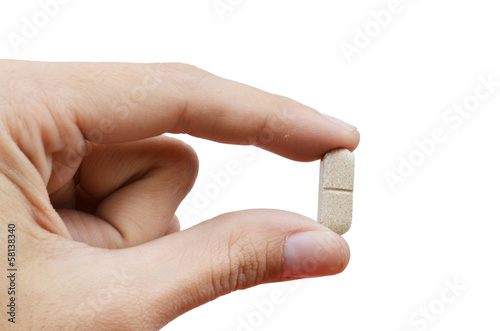 close up hand holding medicine pill