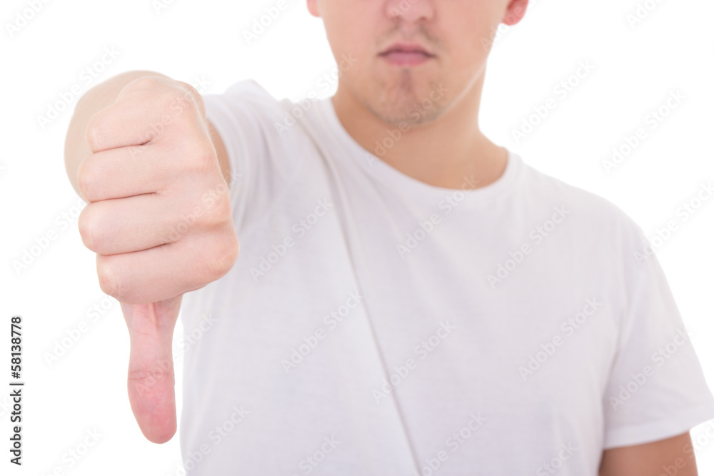 close up of young man showing thumbs down isolated on white close up of young man showing thumbs down isolated on white