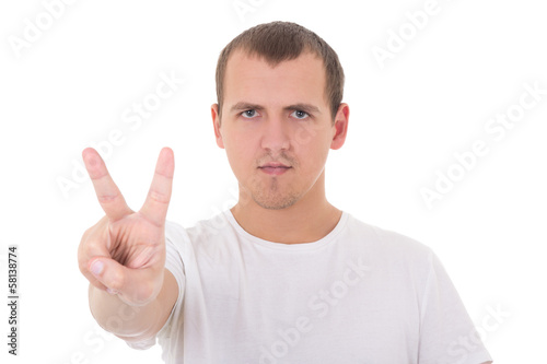 young man in white t-shirt shows a "peace" sign isolated on whi
