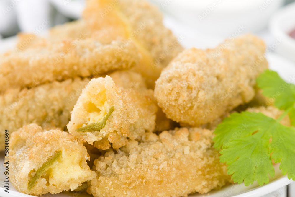 Stuffed Jalapenos - Chilies filled with cheese, breaded & fried Stuffed Jalapenos - Chilies filled with cheese, breaded & fried