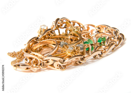 Isolated pile of gold jewelry on white background