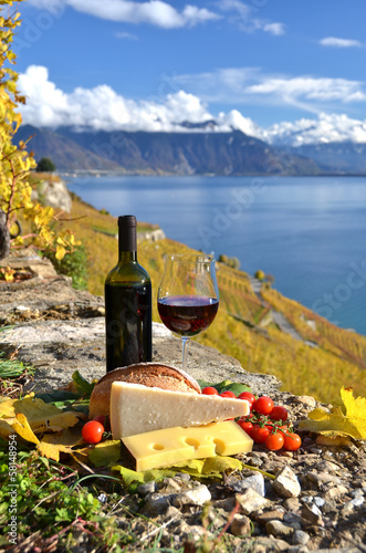 Fototapeta Naklejka Na Ścianę i Meble -  Red wine, chees, bread and cherry tomatos. Lavaux, Switzerland