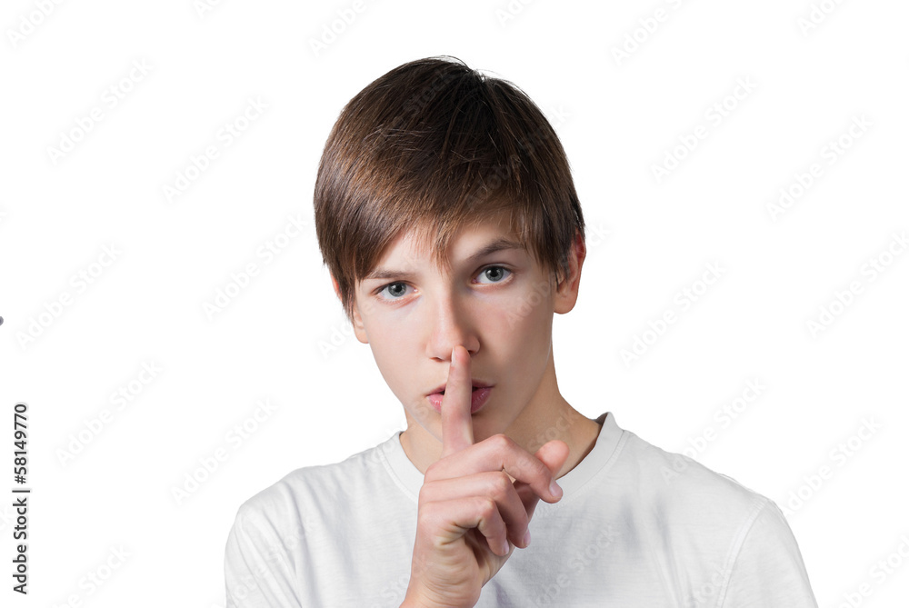 Young smart boy gesturing finger on lips silence Young smart boy gesturing finger on lips silence