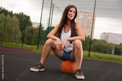 Sexy Woman Sitting On Basketball © maxsaf