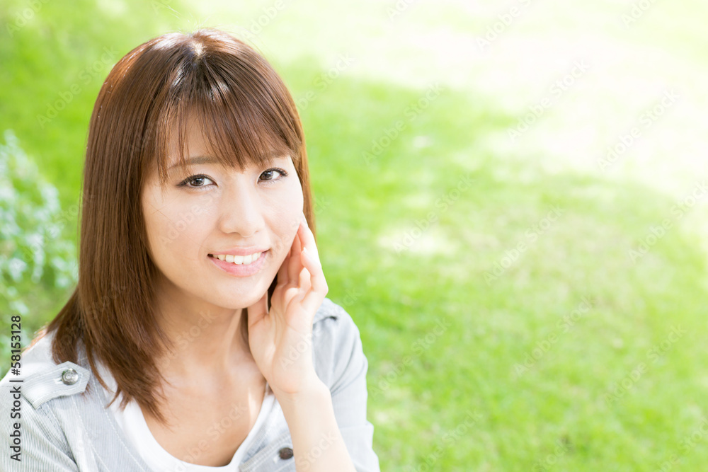 young asian woman relaxing in the park young asian woman relaxing in the park
