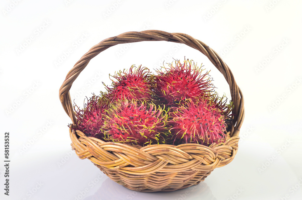 Rambutan in basket on white background