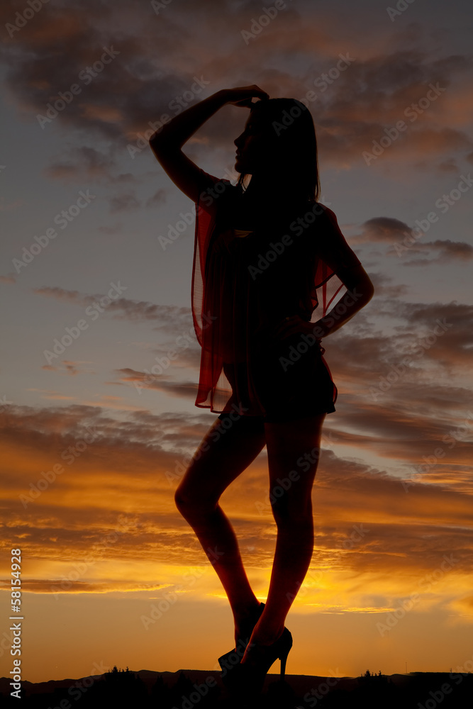 Silhouette woman stand leg knee out hand hair
