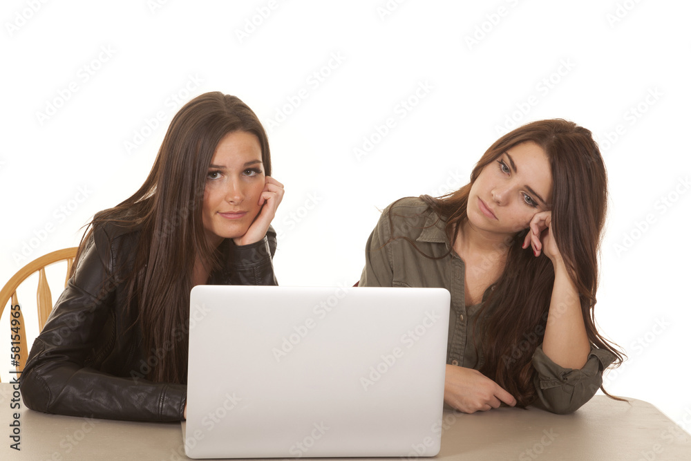 Two women computer one smile one serious Two women computer one smile one serious