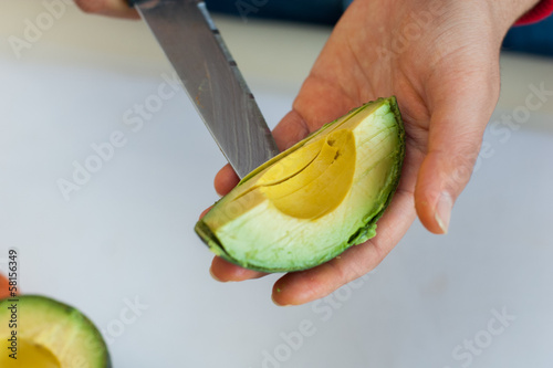 cook cutting an avocado photo