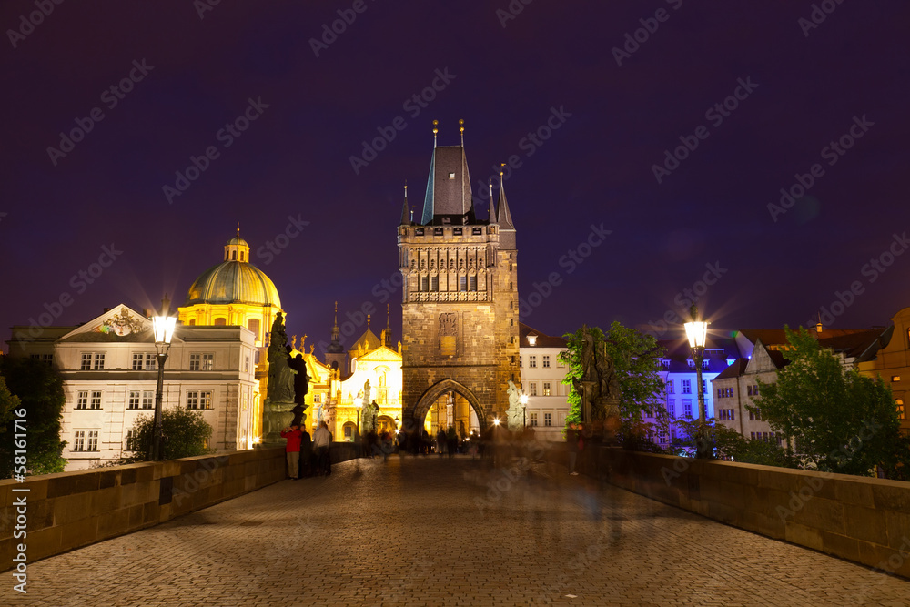 Tourists near Charles bridge in Prague at night