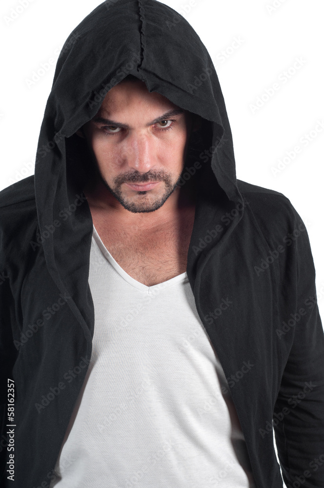 A man in a hood looks askance menacingly A man in a hood looks askance menacingly