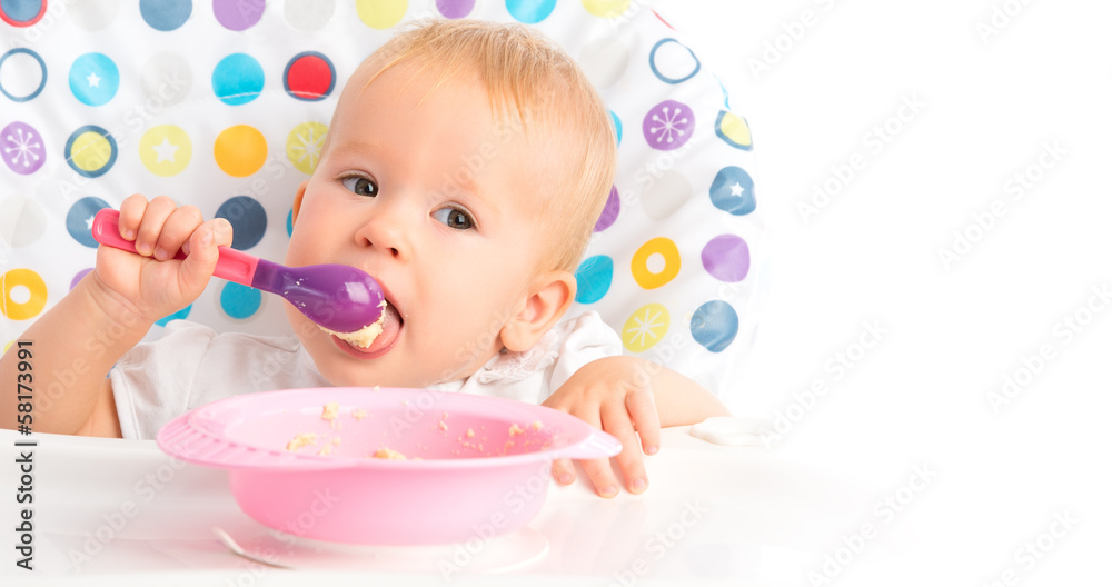 happy baby child eats itself with a spoon happy baby child eats itself with a spoon