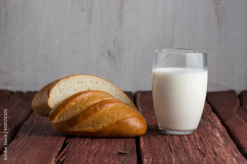 Glass of milk standing on old wooden table Glass of milk standing on old wooden table