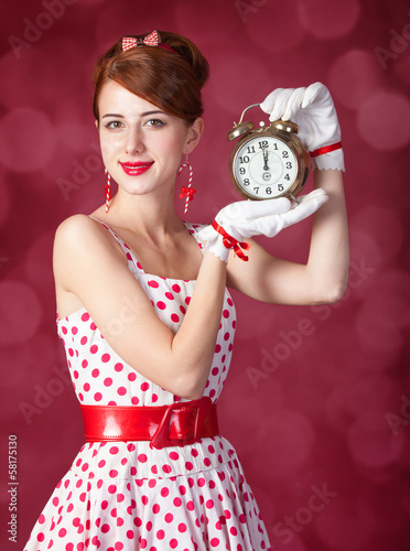 Beautiful redhead women with clock.