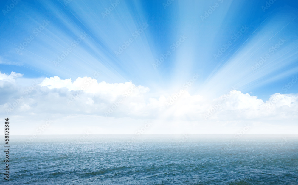 Obraz premium Blue sea with waves and sky with airy clouds