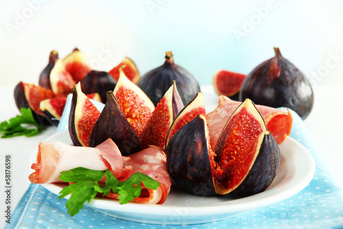 Tasty figs with ham on plate