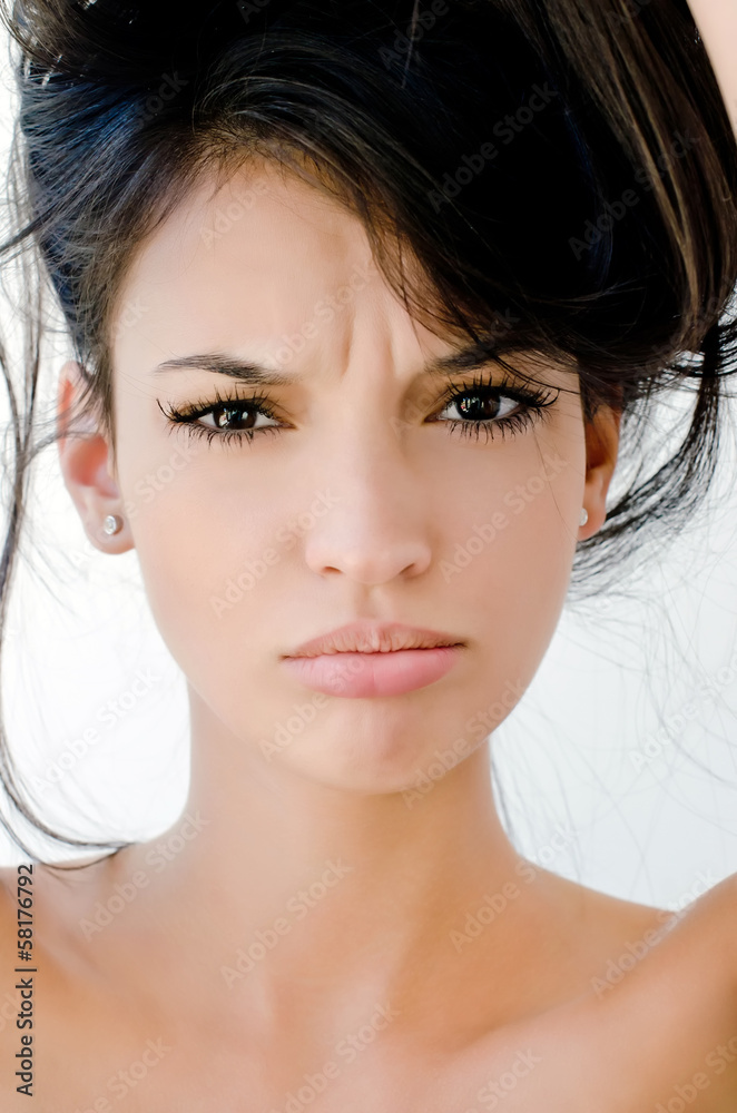 Close up on girl frowning, looking unhappy and stressed. Close up on girl frowning, looking unhappy and stressed.