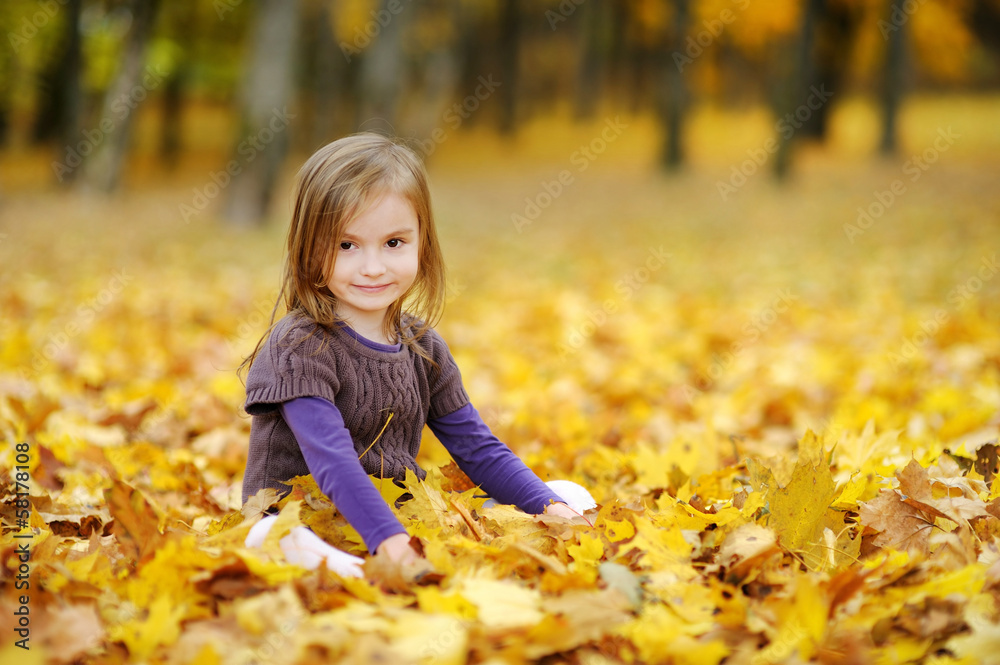 Adorable little girl having fun on autumn day Adorable little girl having fun on autumn day