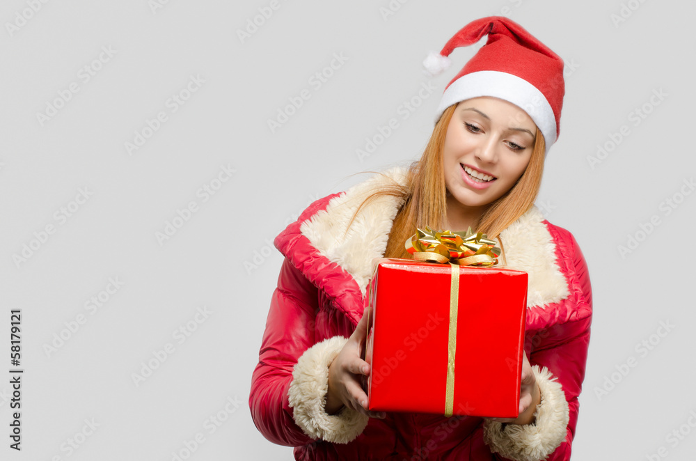 Beautiful red hair woman holding a big Christmas present Beautiful red hair woman holding a big Christmas present