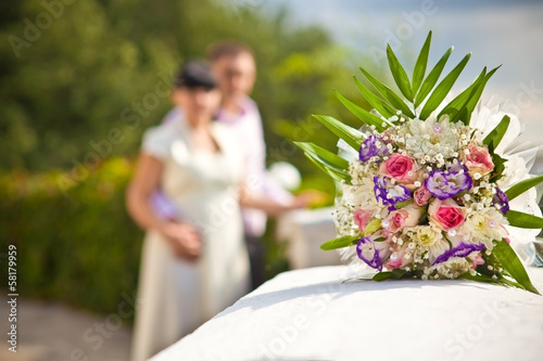 bridal bouquet on the background defocused young couples