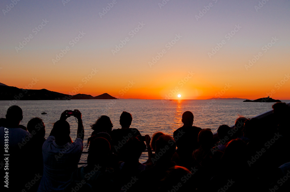 Group of people admiring the sunset, Elba Island, Italy