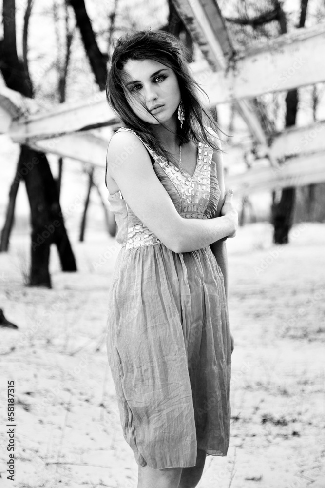 Black and white photo of woman in dress getting cold outdoors Black and white photo of woman in dress getting cold outdoors