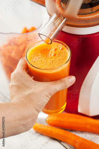 Slow juicer and carrot juice.