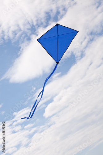 blue kite flying in a beautiful sky clouds