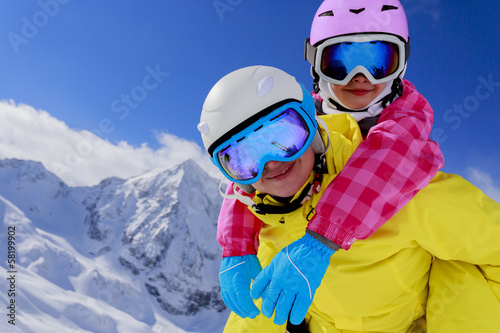 Ski and fun - family enjoying winter holidays