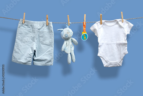 Baby boy clothes on the clothesline photo