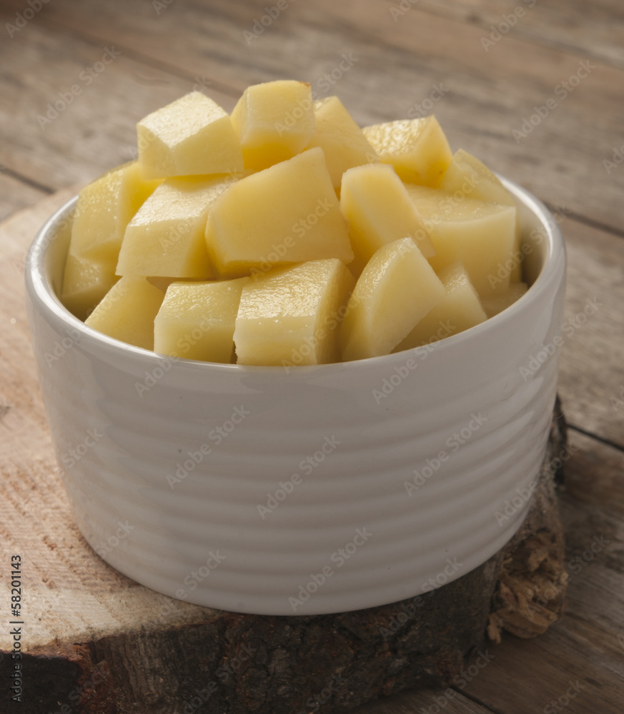 cut raw potatoes in bowl cut raw potatoes in bowl