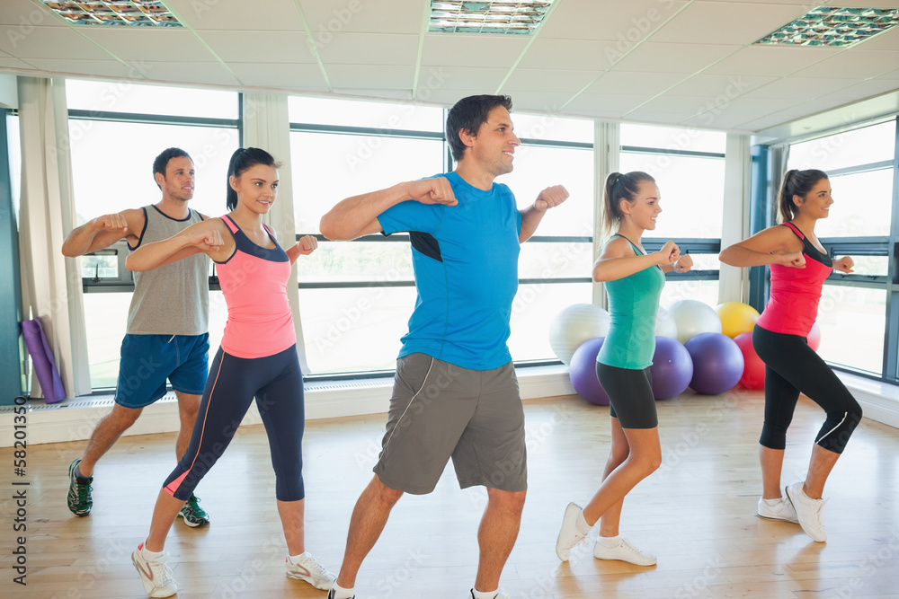 Fitness class and instructor doing pilates exercise Fitness class and instructor doing pilates exercise