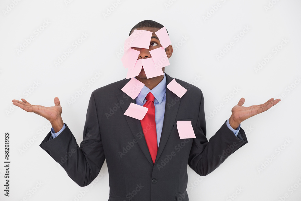 Young Afro businessman covered in blank notes