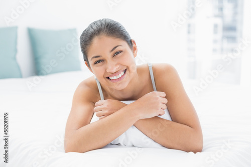 Portrait of a pretty woman lying in bed