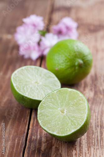 Limes on wood background