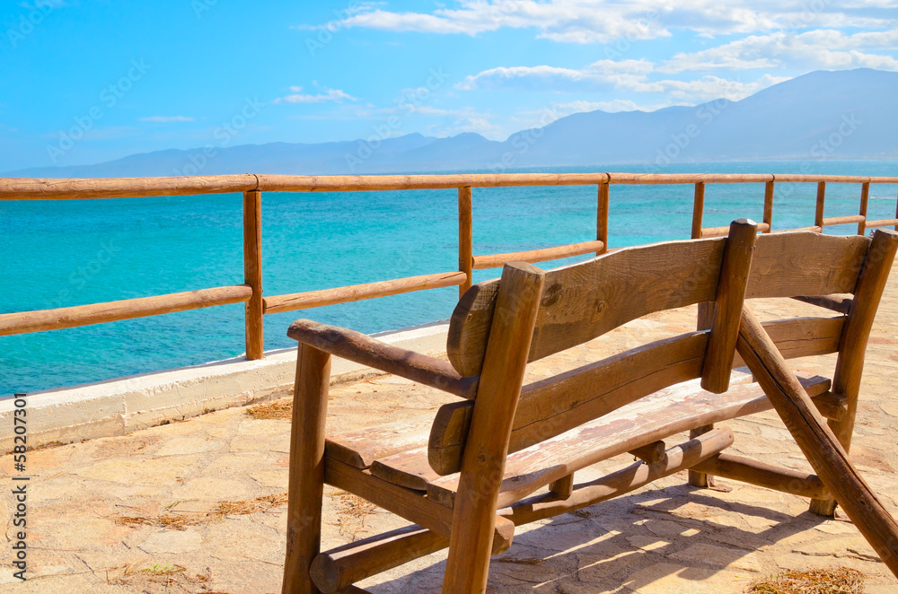 lonely bench on a viewing platform with views of the sea and the