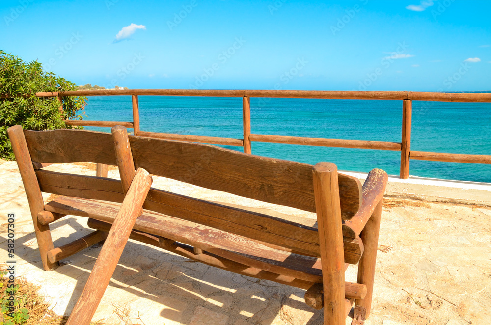 lonely bench on a viewing platform with views of the sea