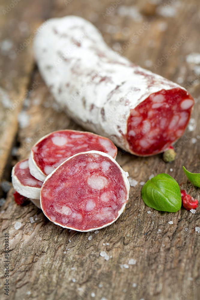 sliced dried salami on rustic wooden table sliced dried salami on rustic wooden table