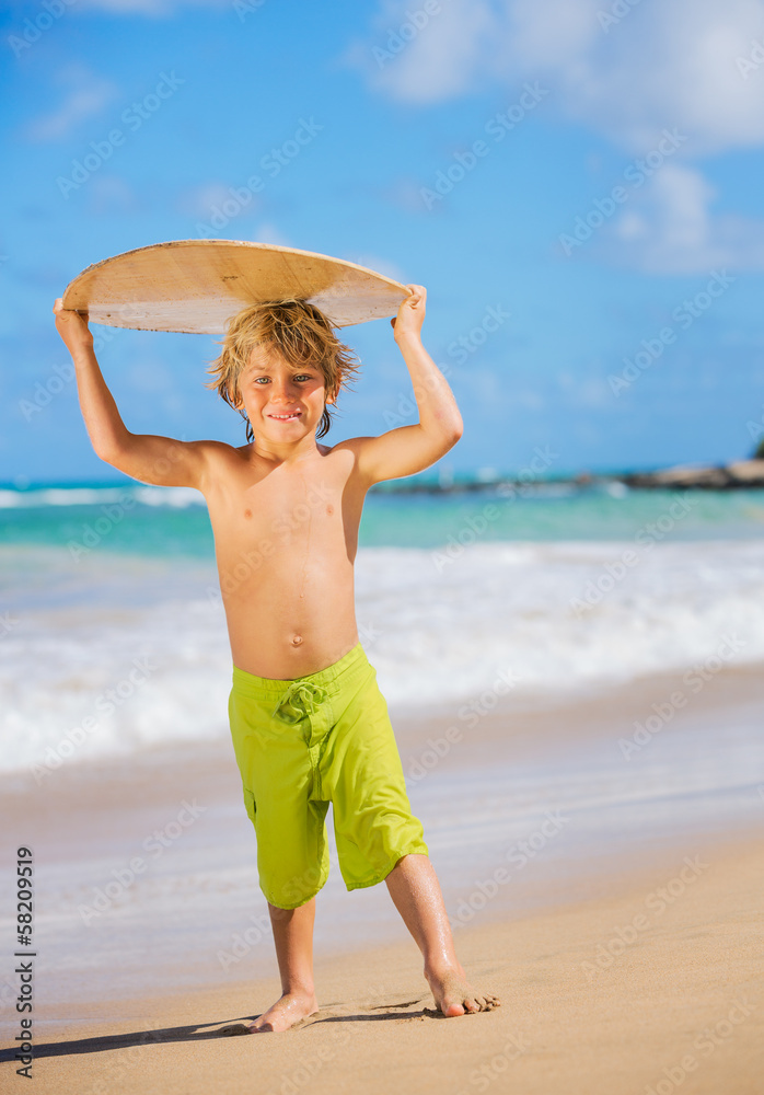 Happy Young boy having fun at the beach on vacation